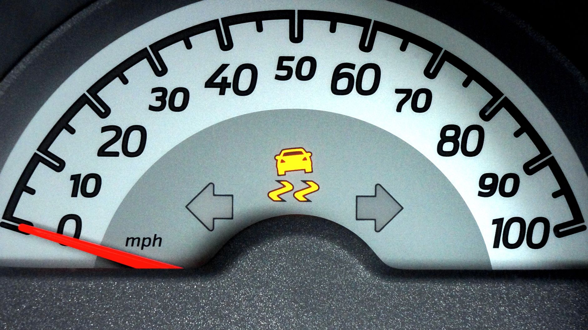 Speedometer with a warning light lit on the dashboard