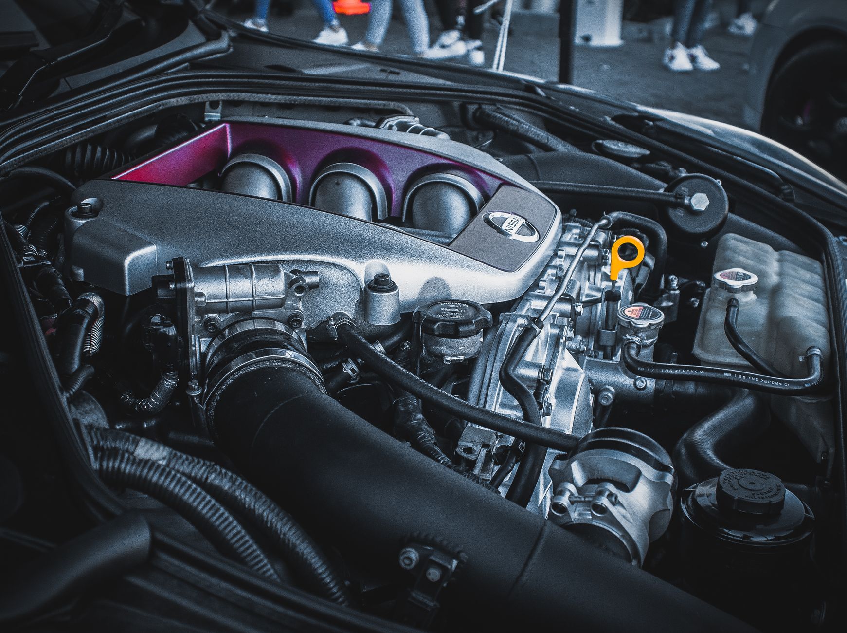 Close-up of a car engine bay under an open hood