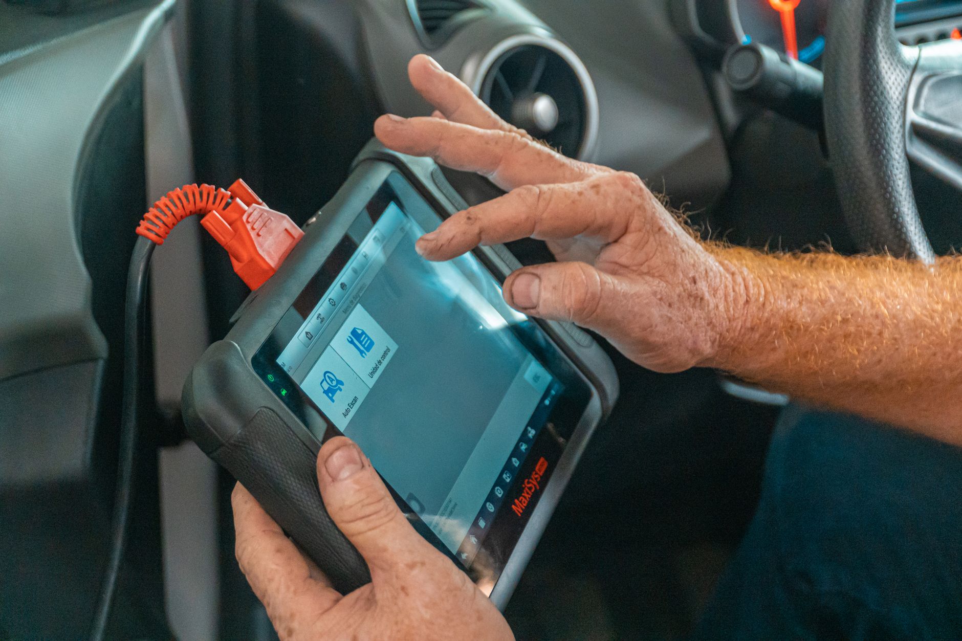 Technician reading a car's diagnostic scanner