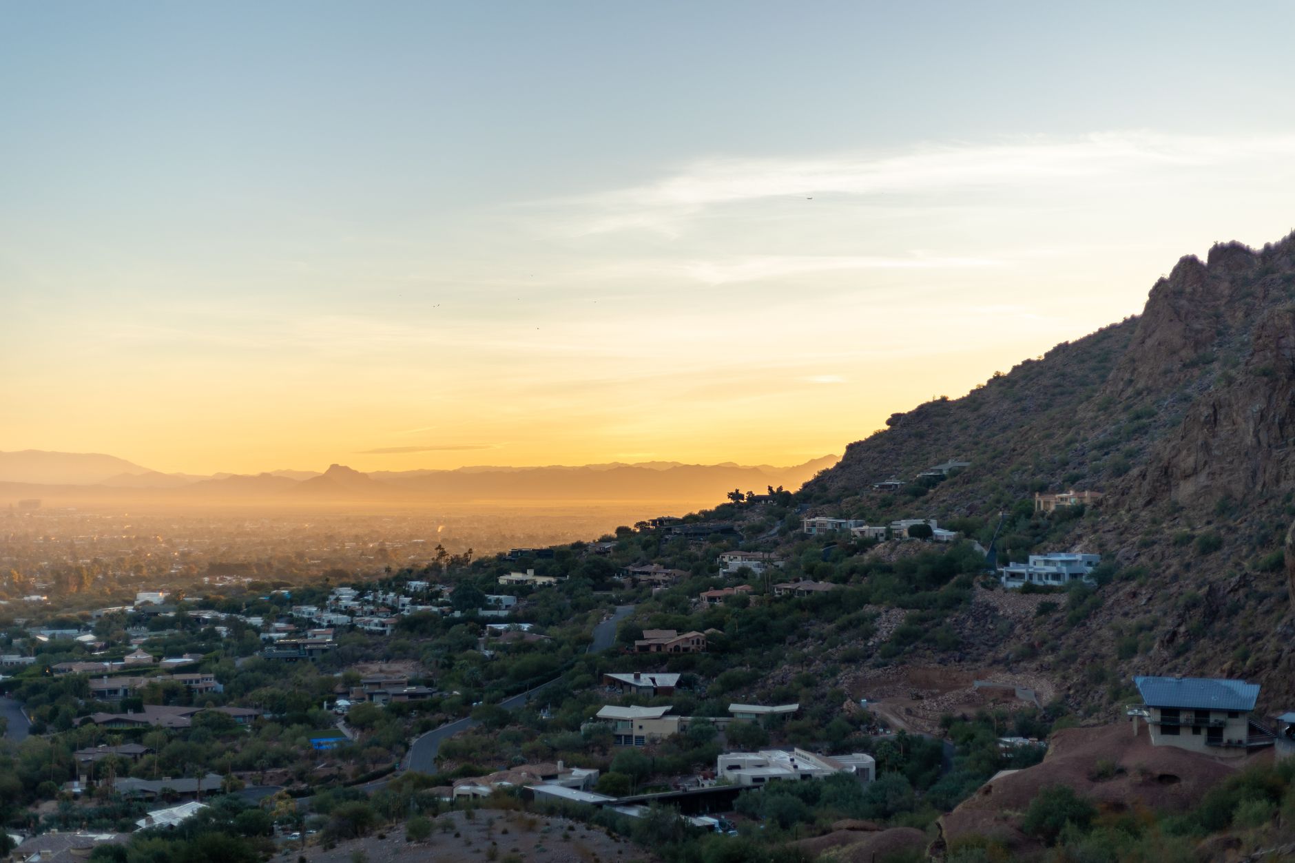 Hillside homes on a desert mountain at sunset in the Phoenix area