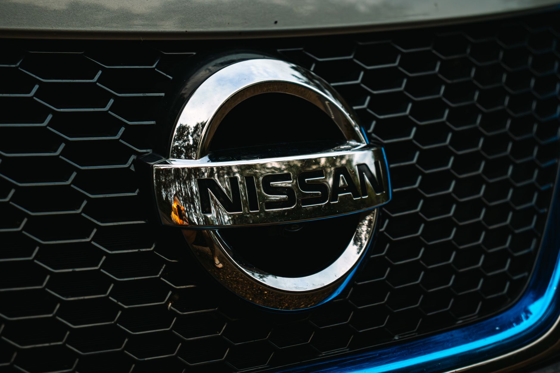 Nissan badge on the front grille of a car
