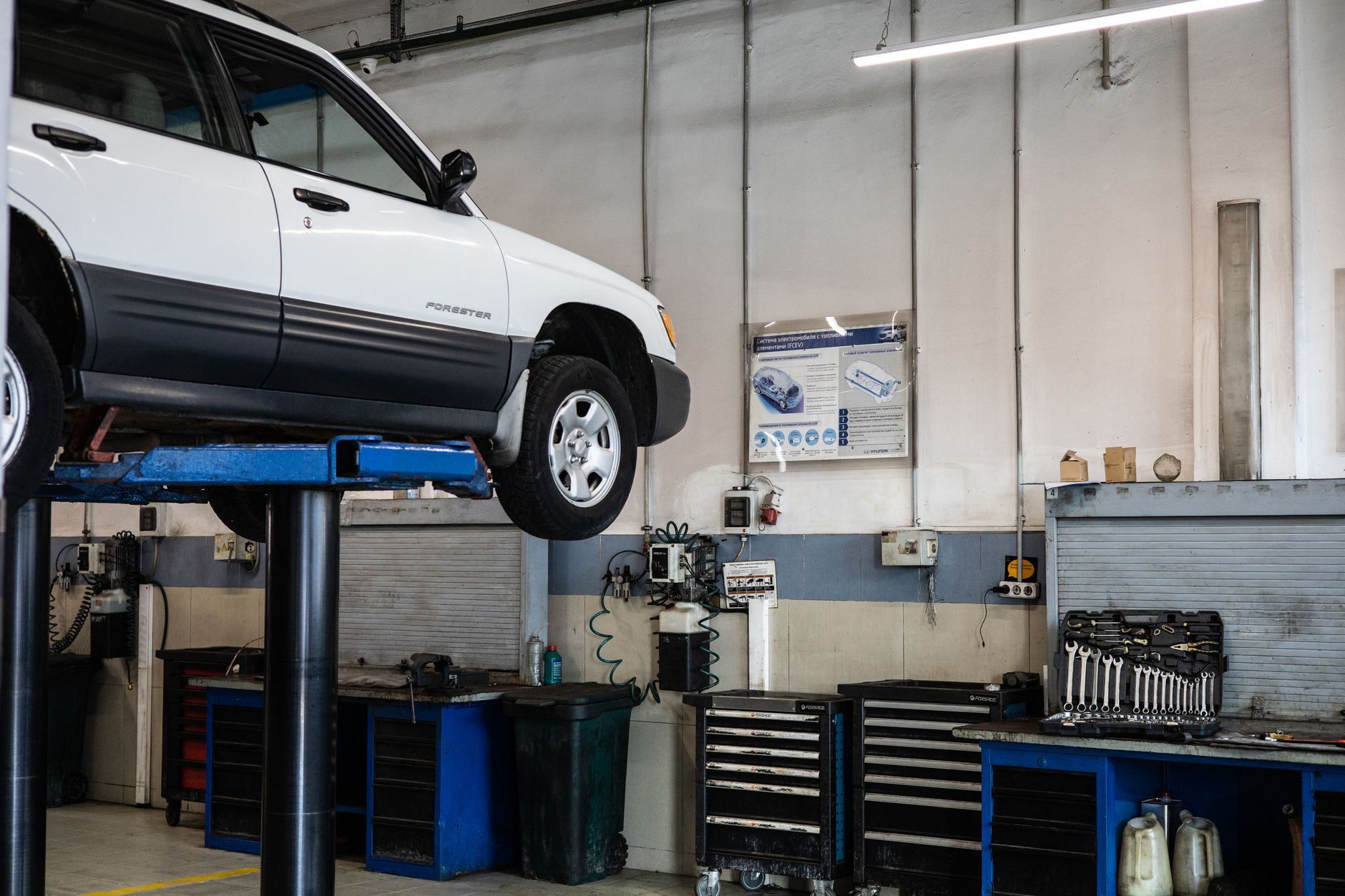 SUV raised on a lift in a repair bay