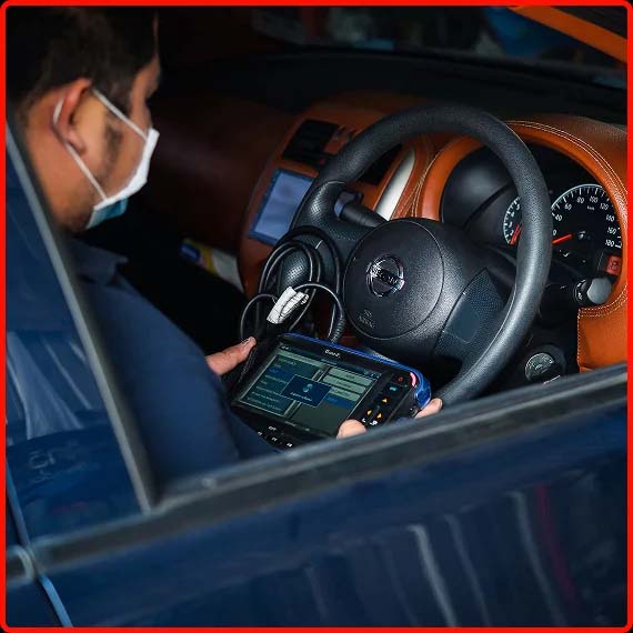 Technician running vehicle diagnostics on a computer at Shift Masters Transmissions in Phoenix AZ