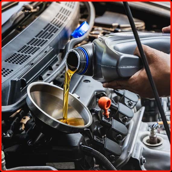 Engine oil being poured into vehicle engine during professional maintenance at Shift Masters Transmissions in Phoenix AZ