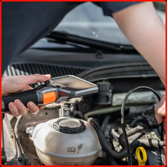 Technician performing electronic system diagnostics on a vehicle at Shift Masters Transmissions Phoenix AZ