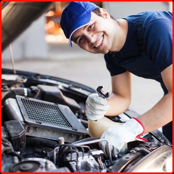 Mechanic inspecting car engine under the hood wearing a hat at Shift Masters Transmissions in Phoenix AZ