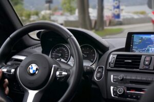 BMW interior with digital displays and logo representing professional BMW transmission diagnostics in Phoenix