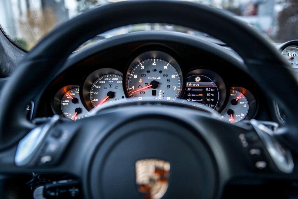 Porsche steering wheel with logo representing luxury vehicle transmission diagnostics at Shift Masters Transmissions Phoenix Arizona