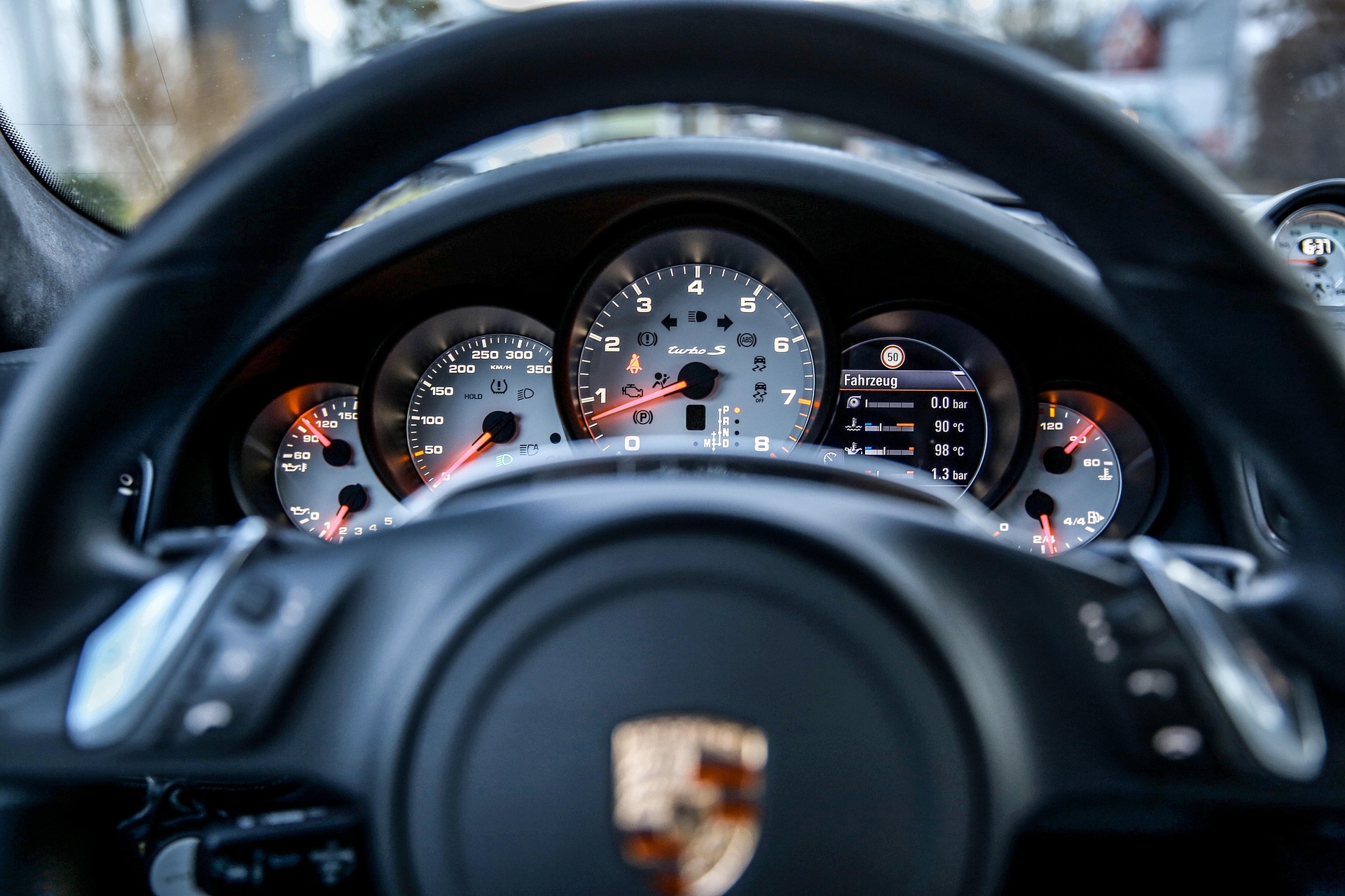 Porsche steering wheel with logo representing luxury vehicle transmission diagnostics at Shift Masters Transmissions Phoenix Arizona