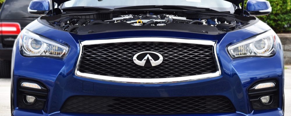 Blue Infiniti sedan with hood open showing diagnostic inspection at Shift Masters Transmissions Phoenix Arizona